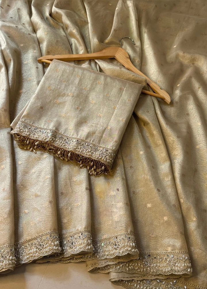 LUXURIOUS IVORY SHADE DESIGNER SOFT TISSUE SILK BOOTI SAREE WITH  LACE ATTACHED