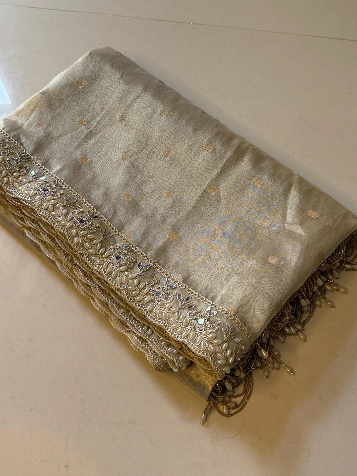 LUXURIOUS IVORY SHADE DESIGNER SOFT TISSUE SILK BOOTI SAREE WITH  LACE ATTACHED